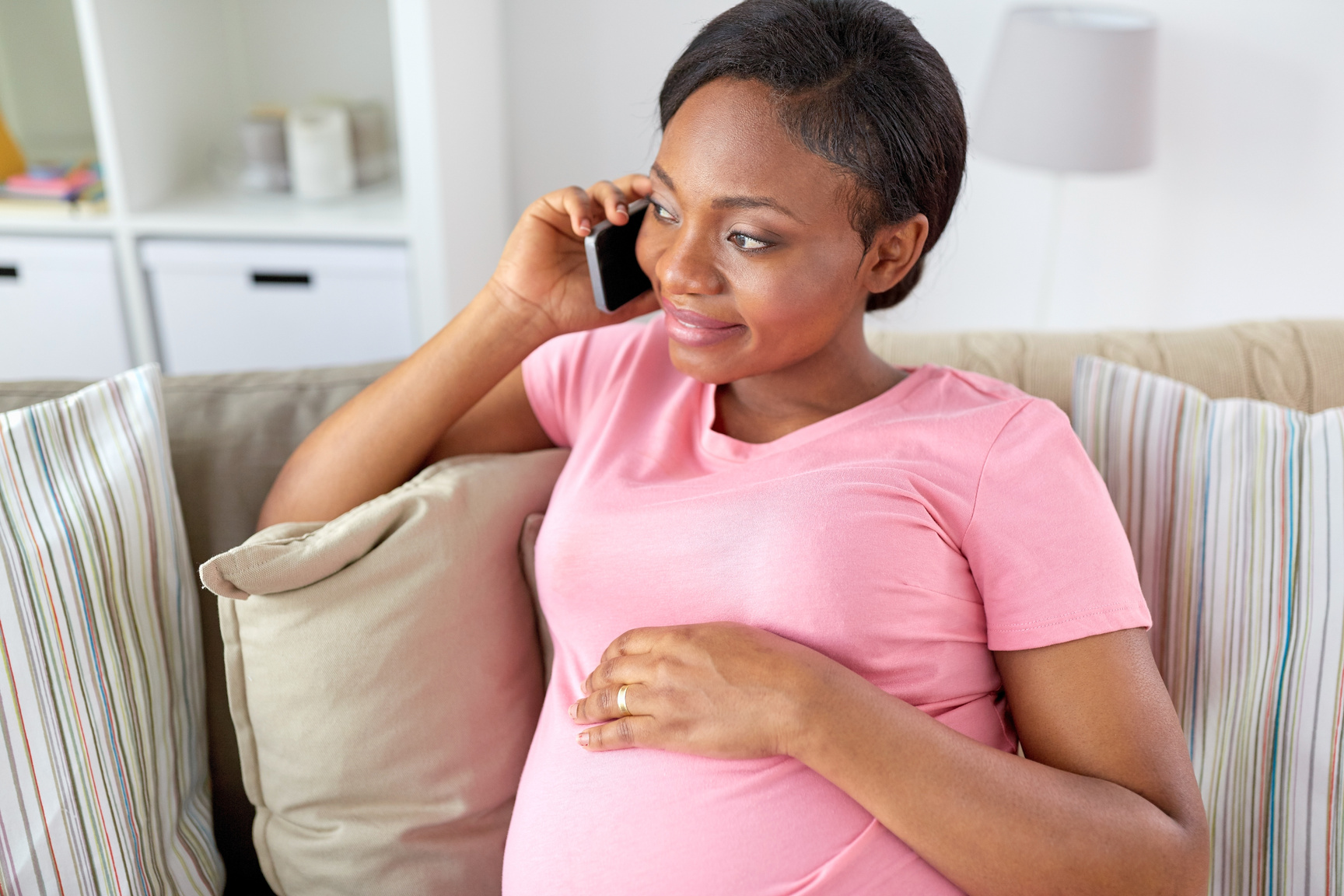 Happy Pregnant Woman Calling on Smartphone at Home